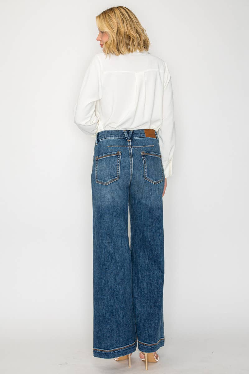 Woman wearing a white blouse and blue jeans on a white background
