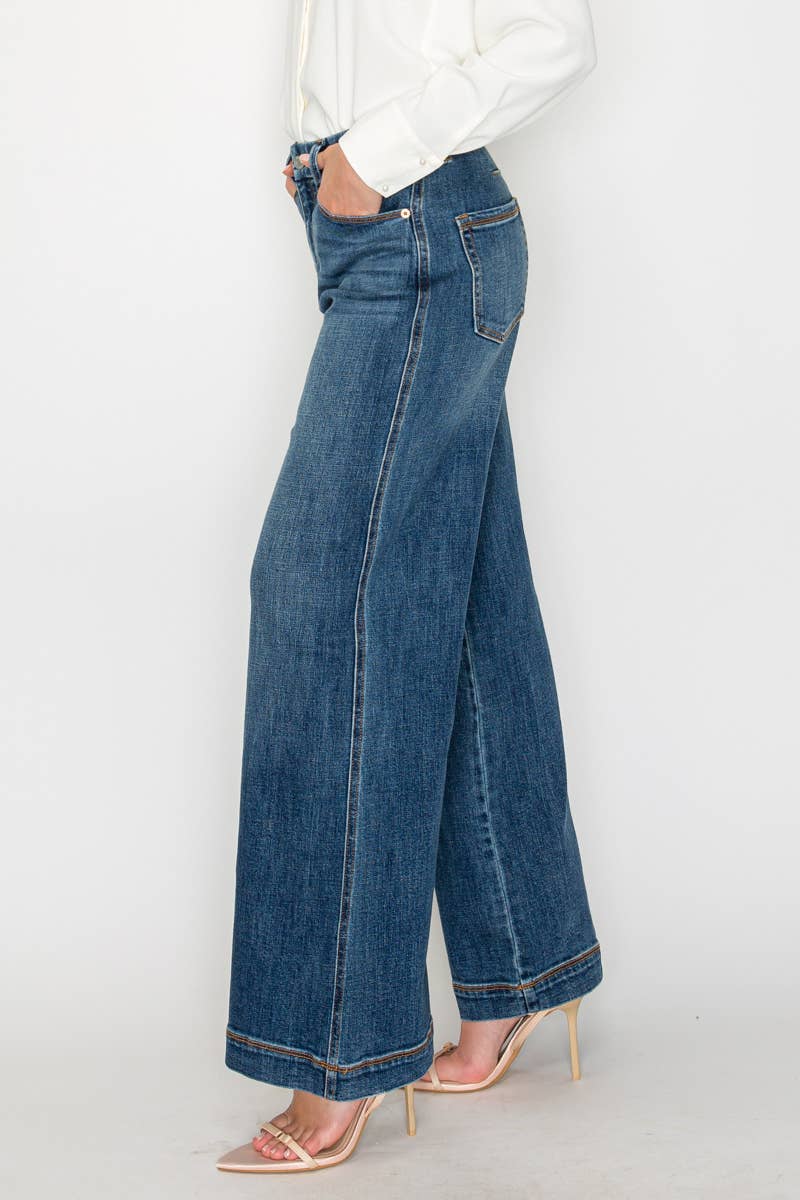 Person wearing blue wide-leg jeans on a white background