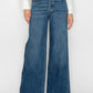 Person wearing blue wide-leg jeans on a white background