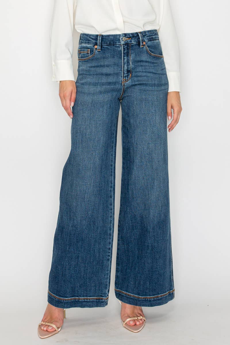 Person wearing blue wide-leg jeans on a white background