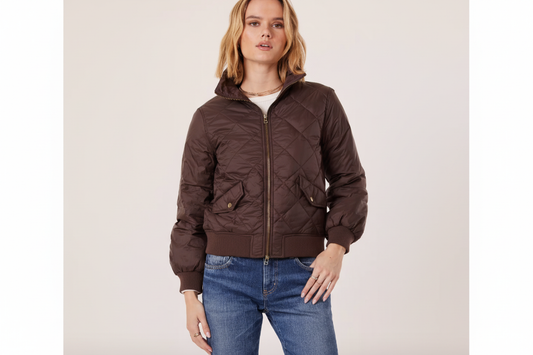 The Leni Jacket in chocolate quilted fabric, worn with jeans